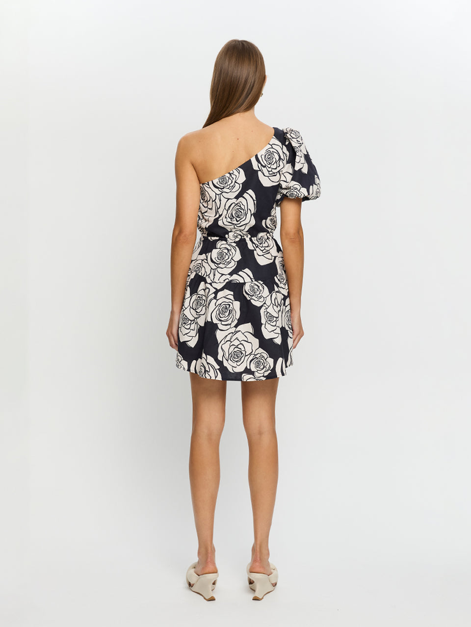 Carmen One Shoulder Mini Dress KIVARI | Model wears navy and white floral mini dress back view