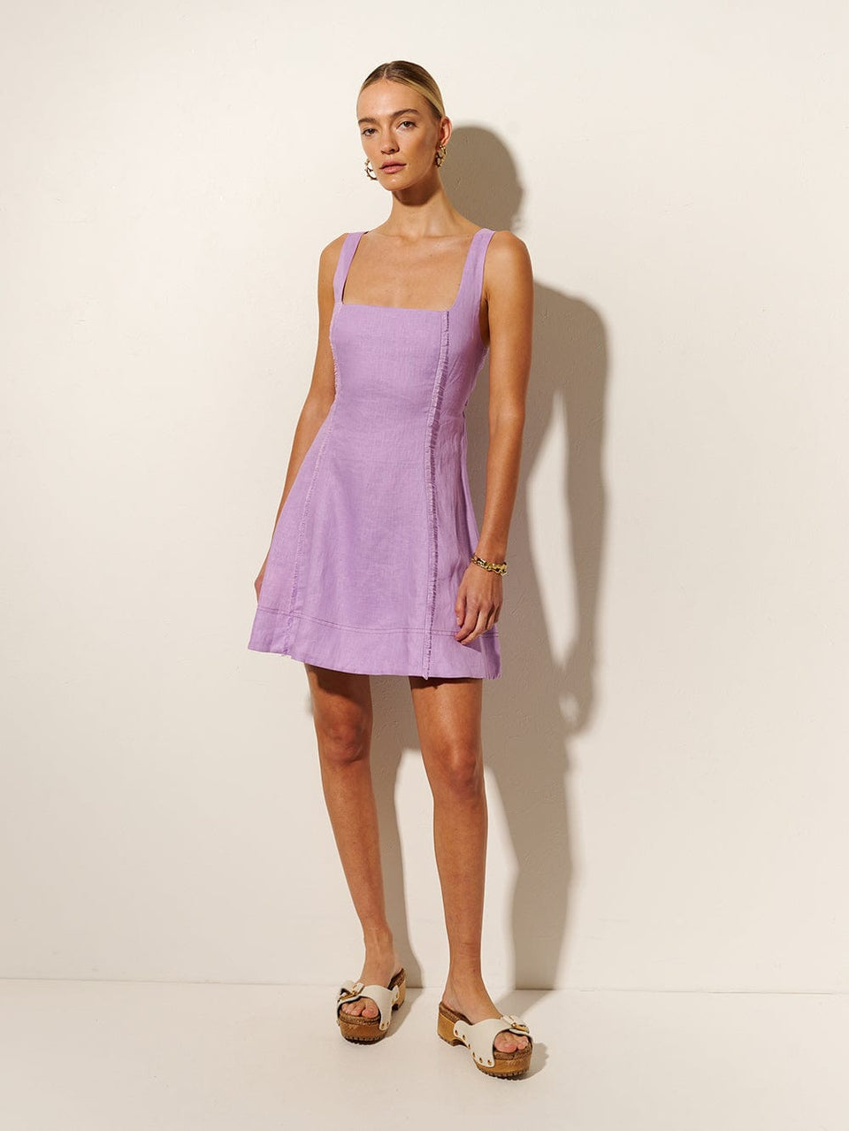 Ellie Strappy Mini Dress KIVARI | Model wears purple mini dress side view