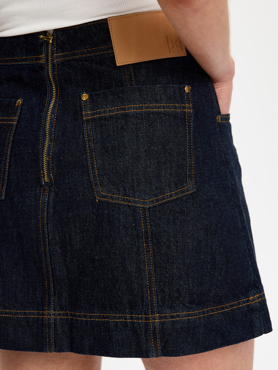 Dark denim skirt with a white background