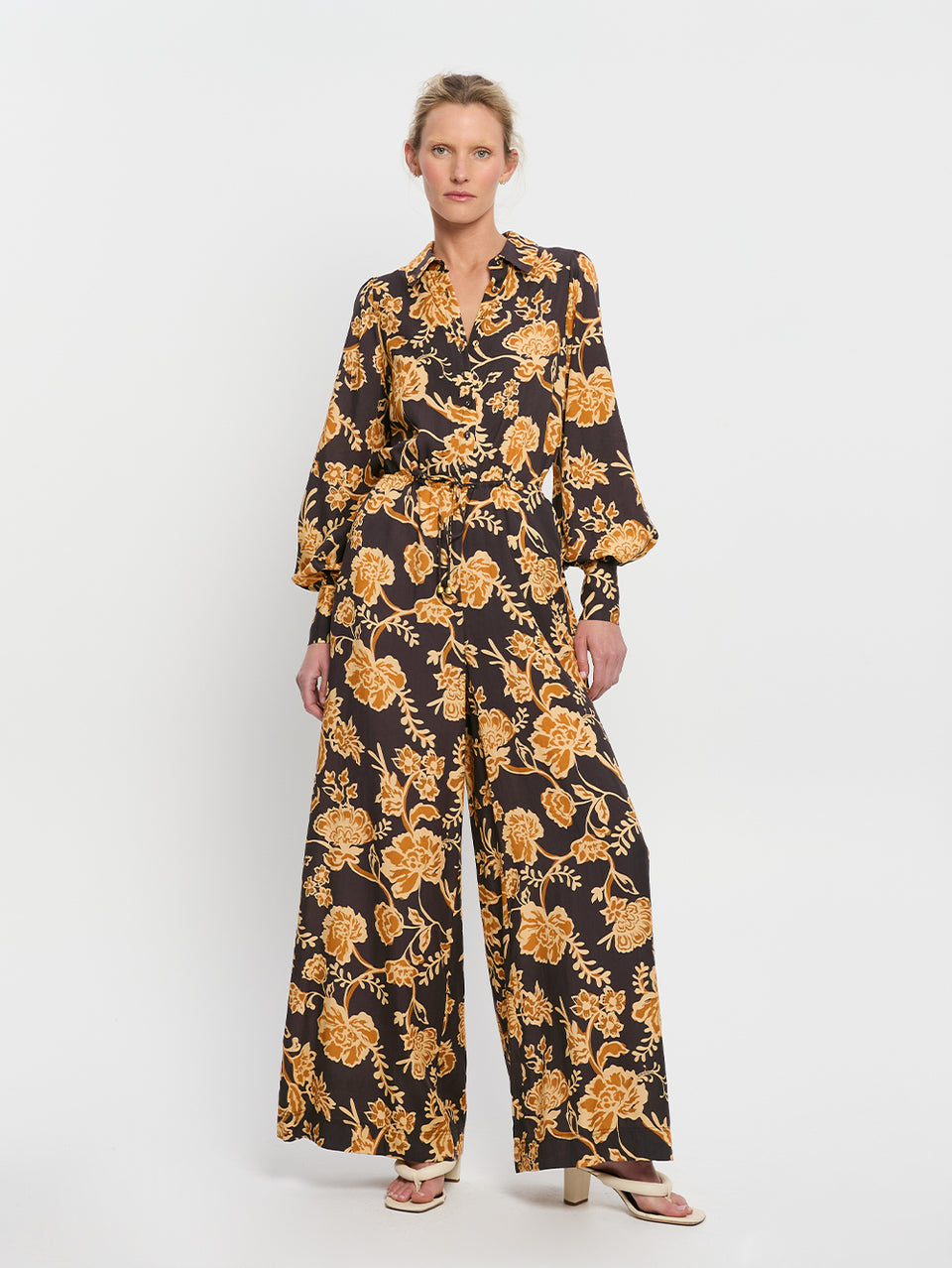 Kaia Jumpsuit KIVARI | Model wears black and orange floral jumpsuit