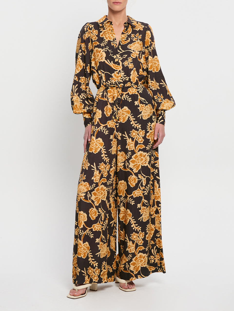 Kaia Jumpsuit KIVARI | Model wears black and orange floral jumpsuit