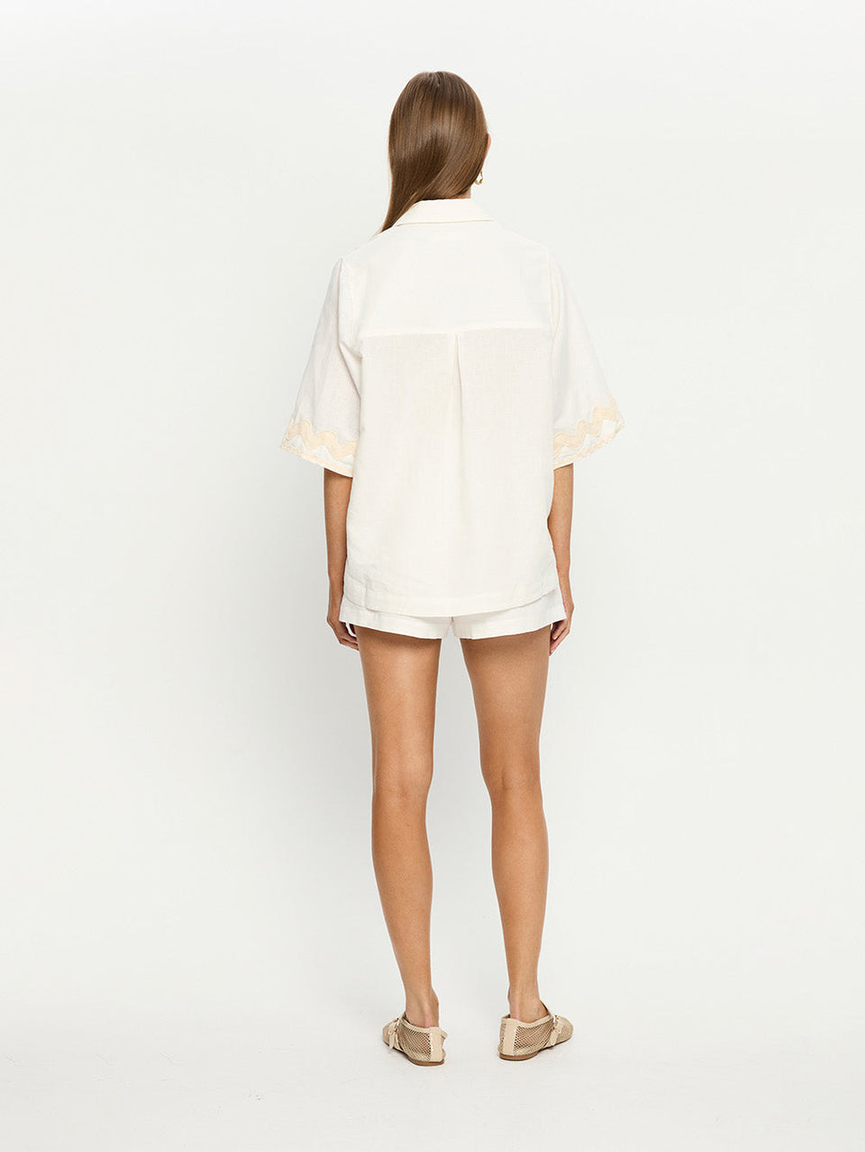 Woman in white linen shirt