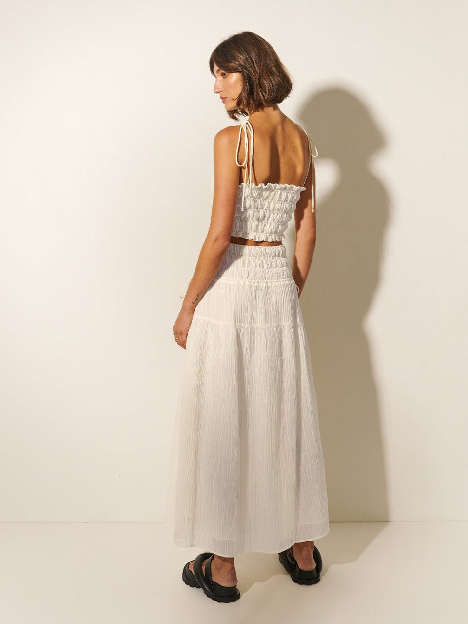 Nora Crop Top KIVARI | Model wears ivory crop top with matching skirt back view