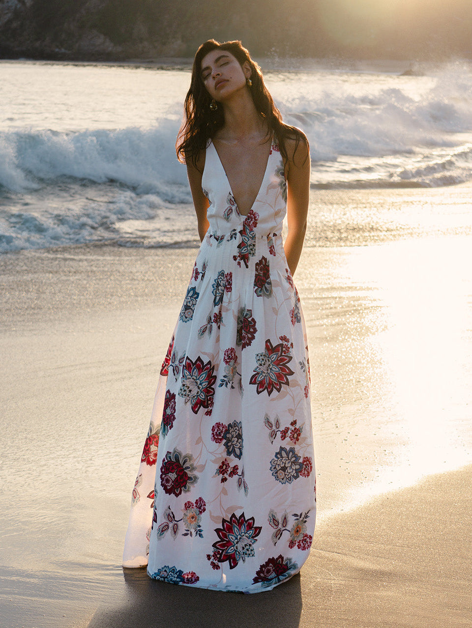 Woman in floral maxi dress on beach