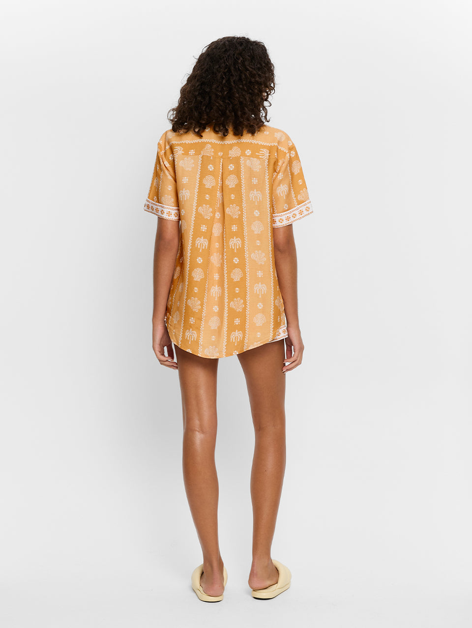 Sienna Shirt KIVARI | Model wears orange print shirt back view
