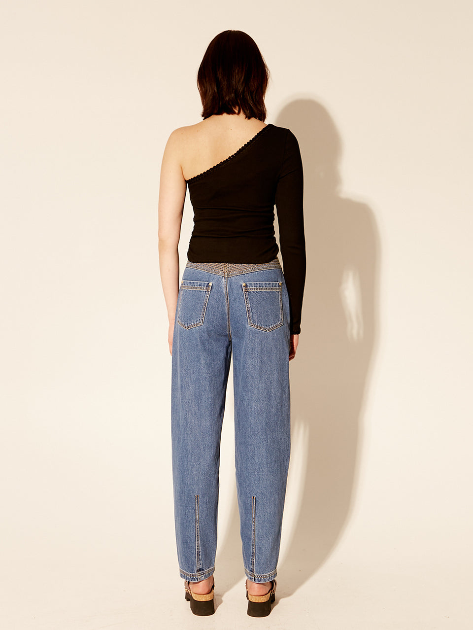 Tallulah One Shoulder Top Black KIVARI | Model wears black one shoulder top back view