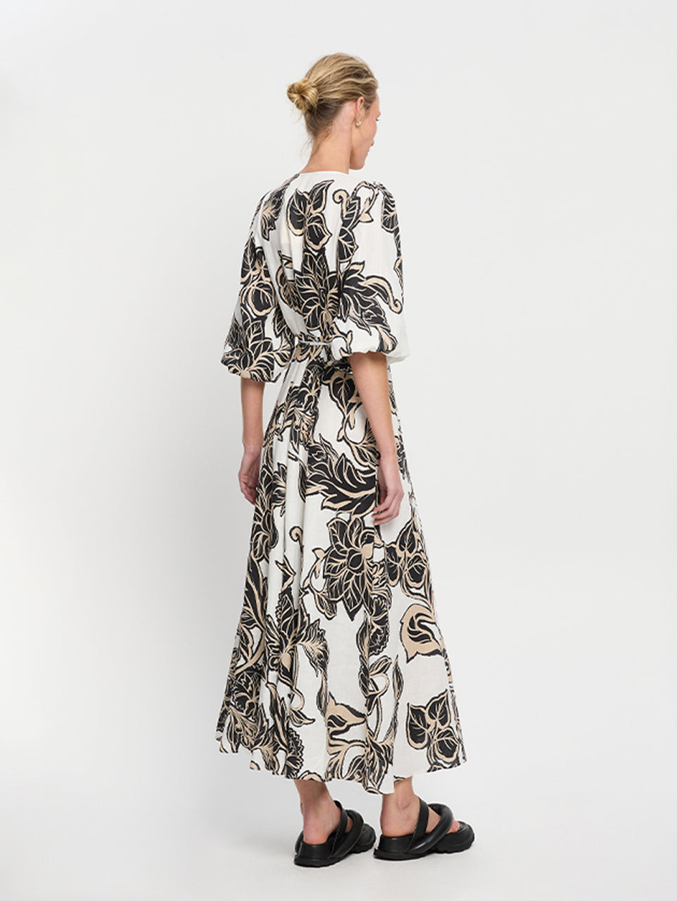 Alma Maxi Dress KIVARI | Model wears black and white floral maxi dress side view