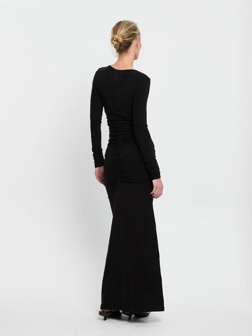 Amal Maxi Dress Black KIVARI | Model wears black maxi dress back view