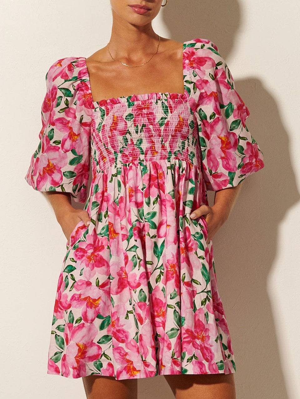 KIVARI Antonia Shirred Mini Dress | Model wearing Pink and Green Floral Mini Dress