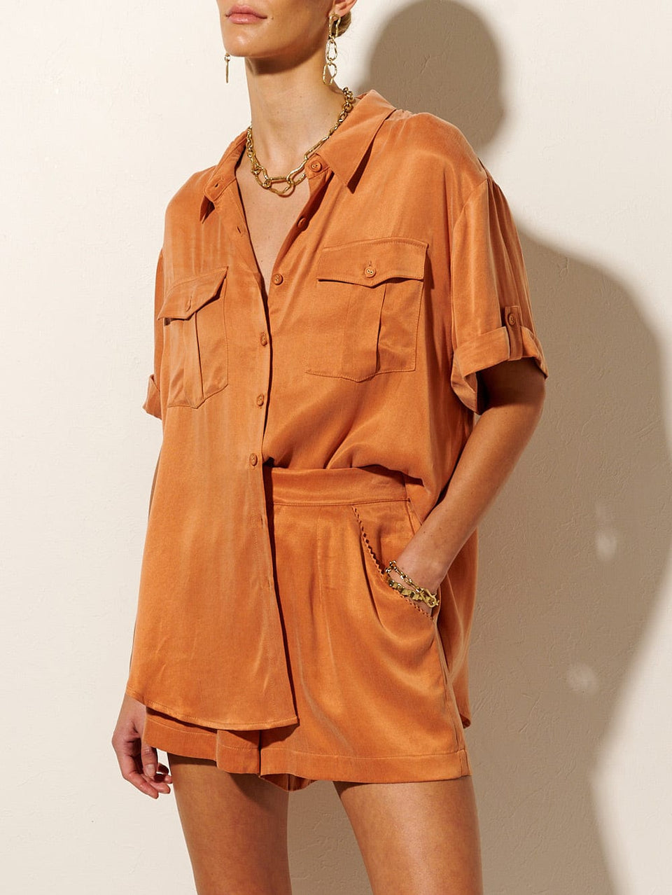 KIVARI Bianca Short | Model wears Orange Shorts Close Up