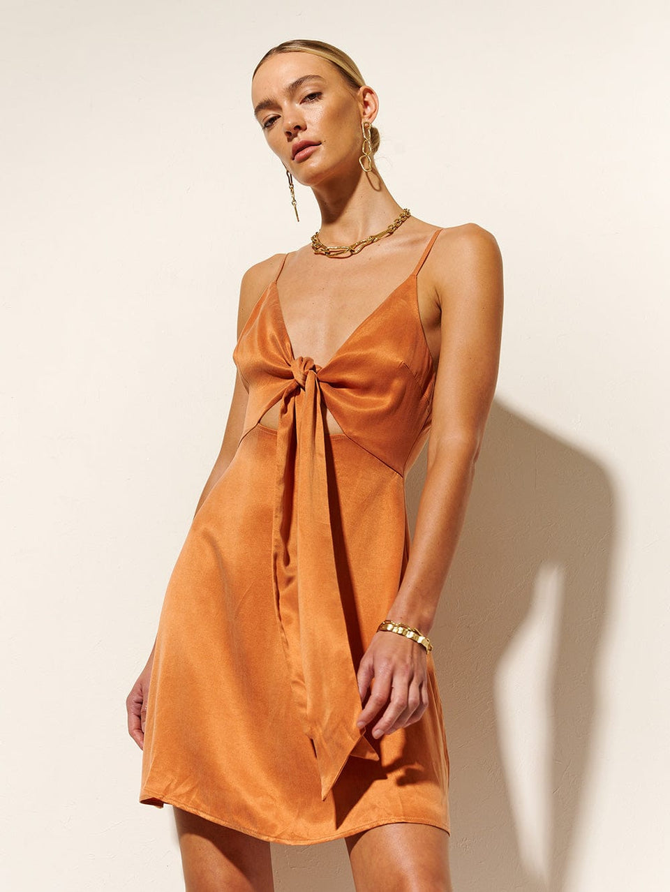 KIVARI Bianca Tie Front Mini Dress | Model wears Orange Tie Front Mini Dress Close Up