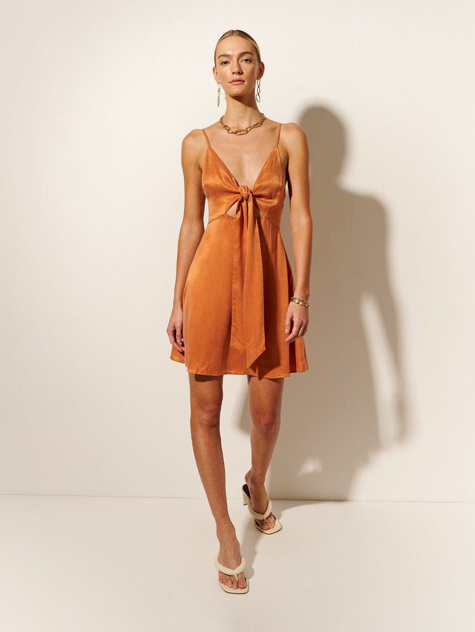 KIVARI Bianca Tie Front Mini Dress | Model wears Orange Tie Front Mini Dress