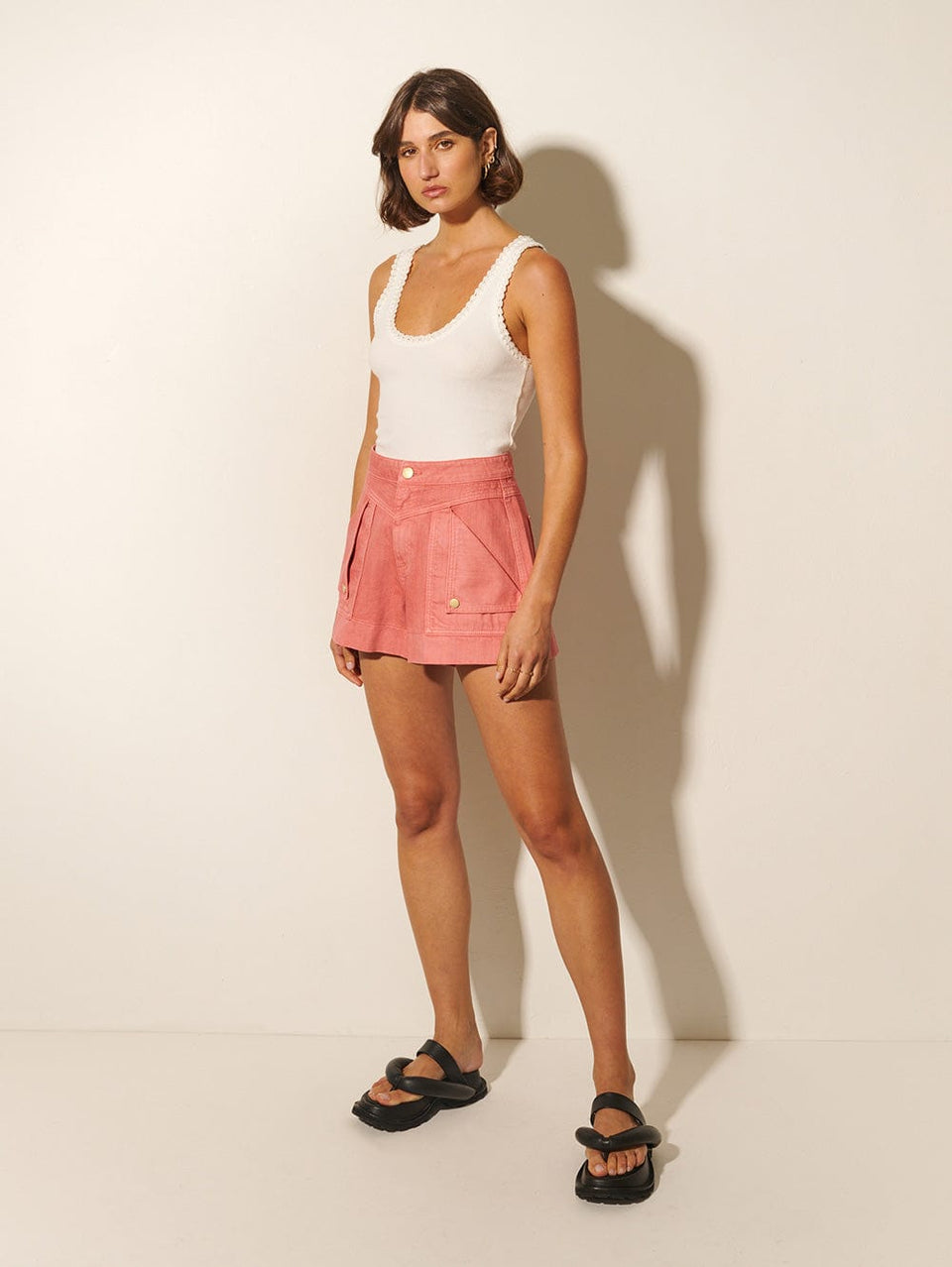 Celene Short KIVARI | Model wears pink denim shorts side view