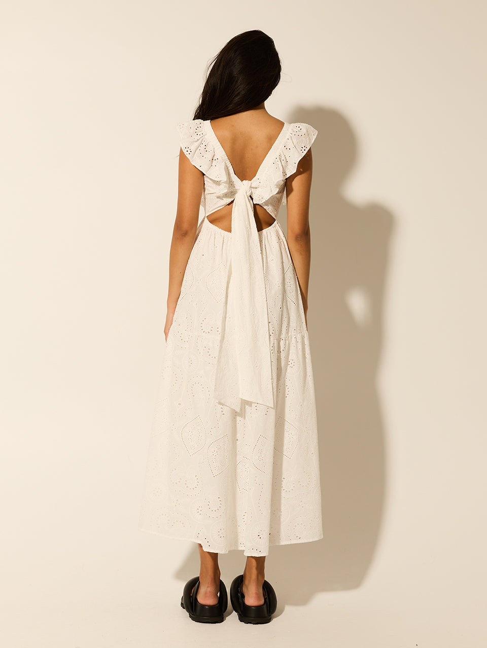 Clove Midi Dress KIVARI | Model wears white embroidered midi dress back view