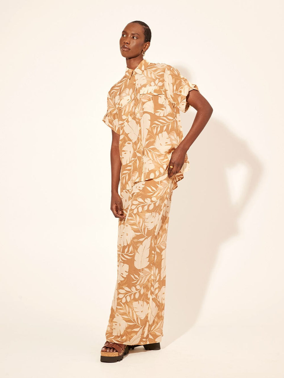 Cove Shirt KIVARI | Model wears neutral coloured leaf printed shirt side view
