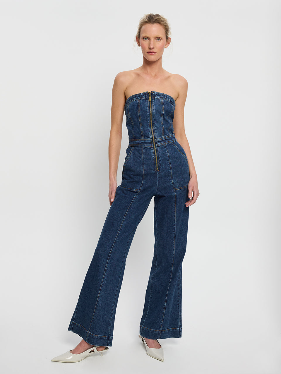 Dani Jumpsuit Indigo KIVARI | Model wears indigo blue denim strapless jumpsuit