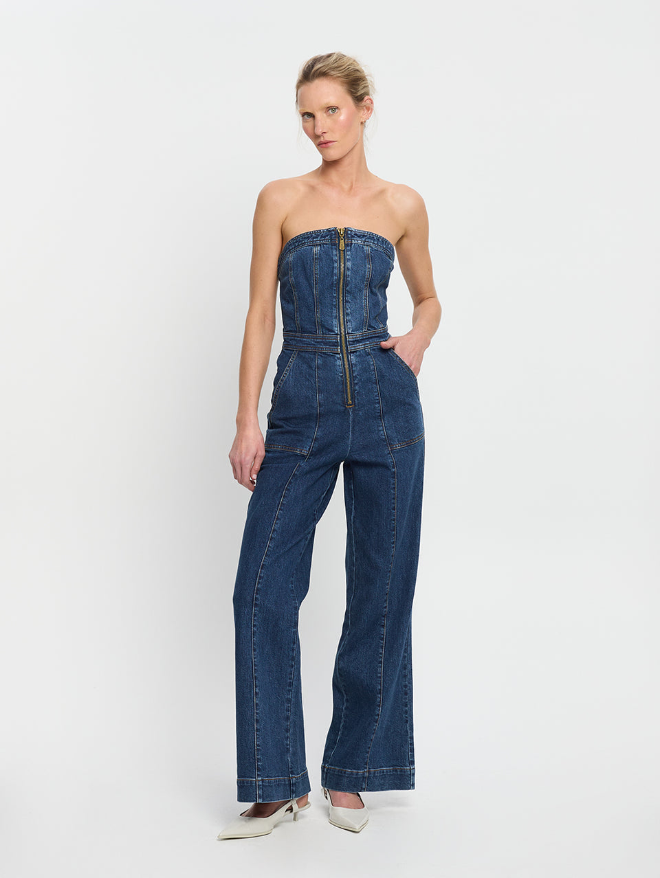 Dani Jumpsuit Indigo KIVARI | Model wears indigo blue denim strapless jumpsuit 