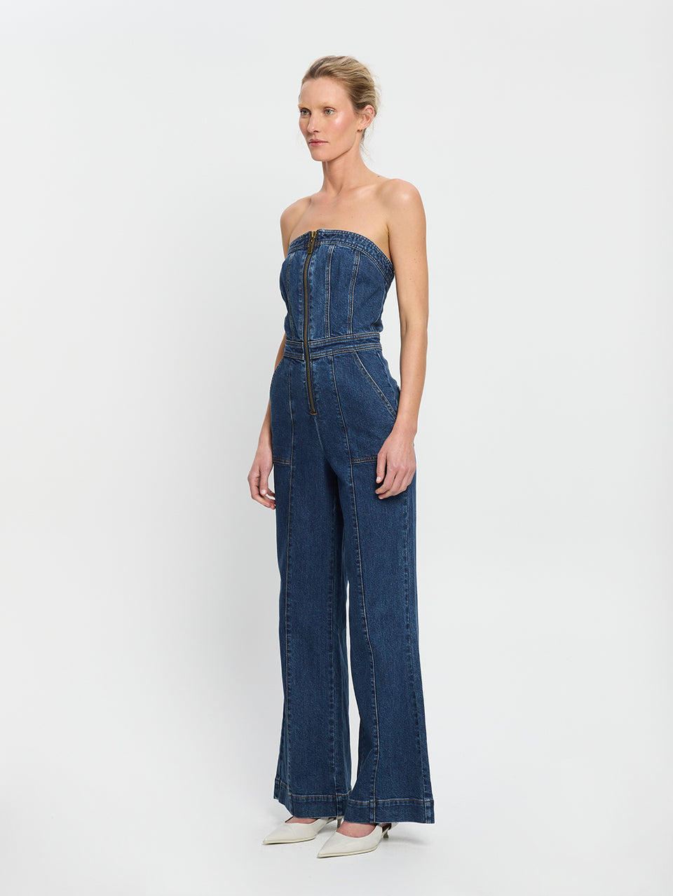 Dani Jumpsuit Indigo KIVARI | Model wears indigo blue denim strapless jumpsuit side view