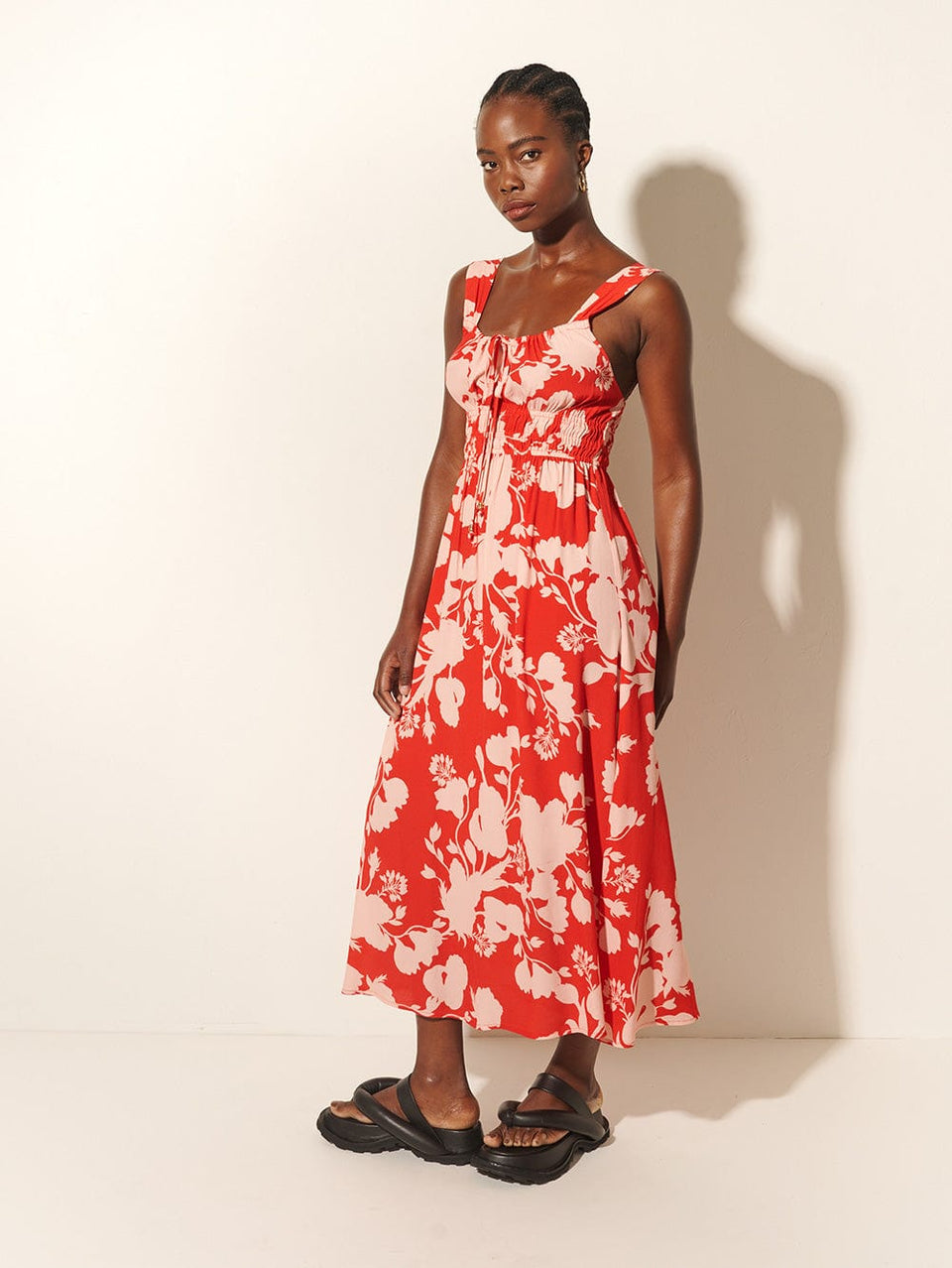 Delfina Midi Dress KIVARI | Model wears red and pink floral midi dress side view