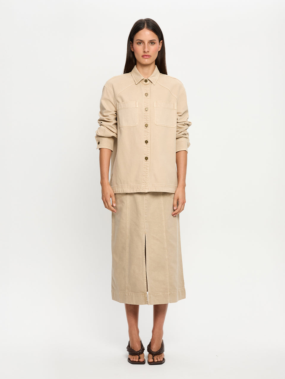Woman wearing a beige outfit on a white background