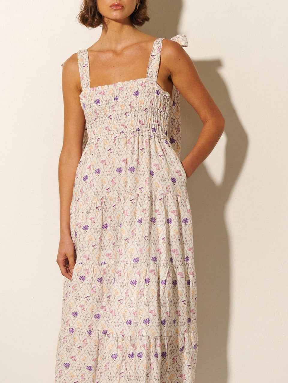 Fleur Midi Dress KIVARI | Model wears white and purple floral print midi dress close up