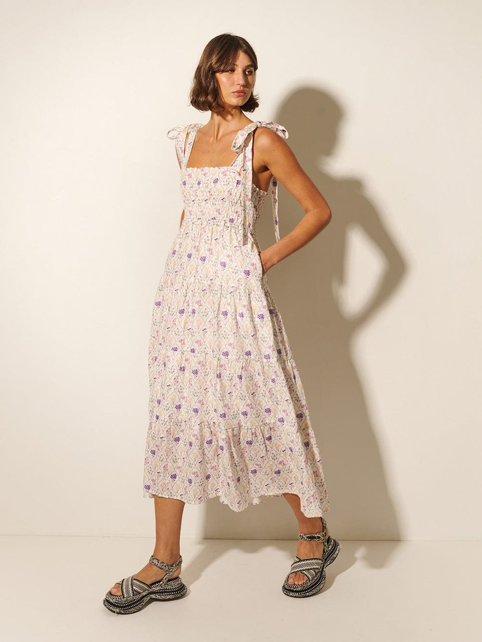 Fleur Midi Dress KIVARI | Model wears white and purple floral print midi dress side view