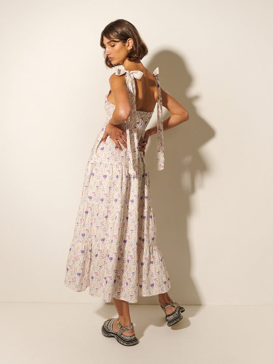 Fleur Midi Dress KIVARI | Model wears white and purple floral print midi dress back view