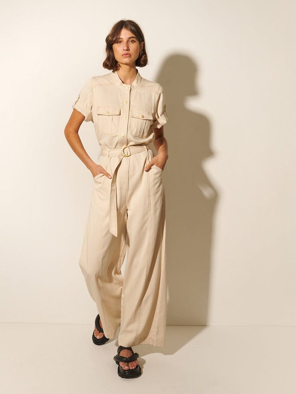 Gianna Jumpsuit KIVARI | Model wears cream short sleeve jumpsuit