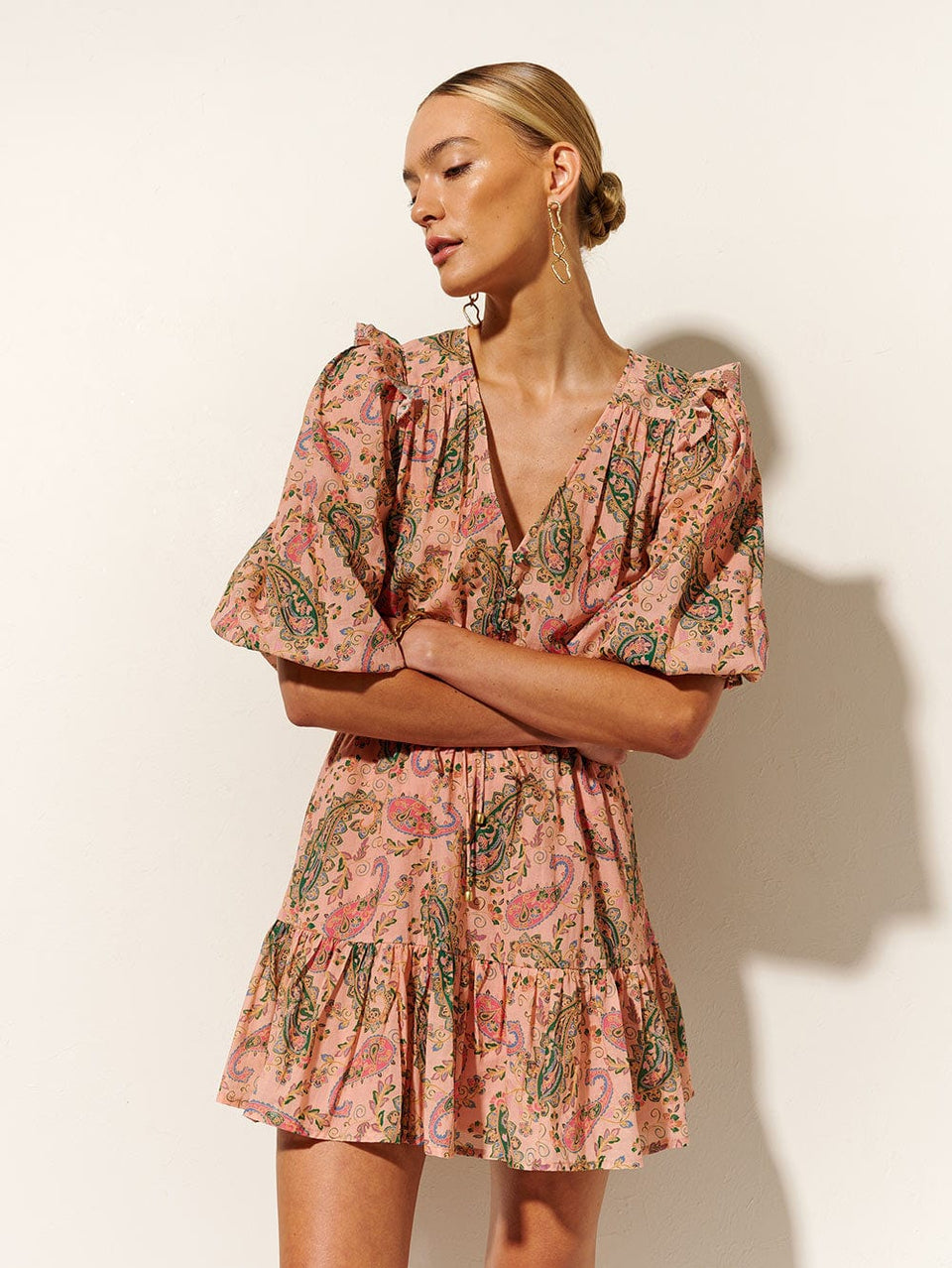 Isha Ruffle Mini Dress KIVARI | Model wears ruffle pink paisley mini dress 