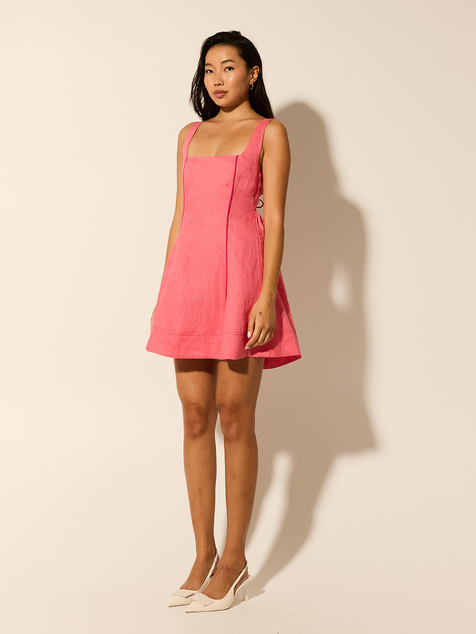 Jenna Mini Dress KIVARI | Model wears pink mini dress side view