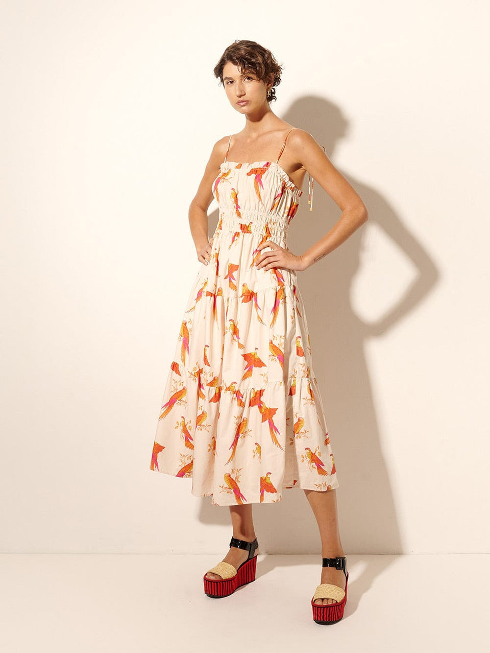 Kaylee Midi Dress KIVARI | Model wears pink and orange bird print midi dress side view