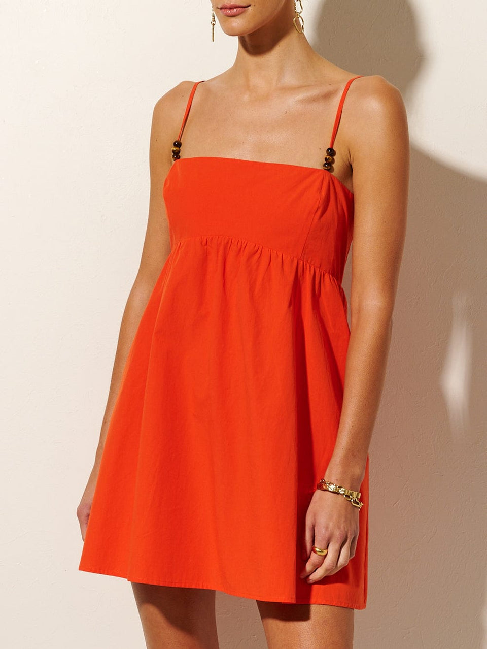 Kennedy Strappy Mini Dress KIVARI | Model wears red mini dress close up
