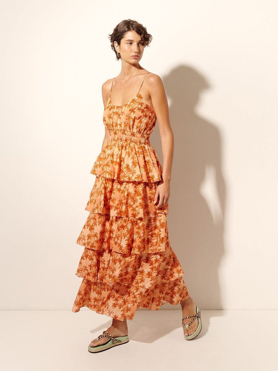 Leilani Maxi Dress KIVARI | Model wears bronze and peach palm printed maxi dress side view