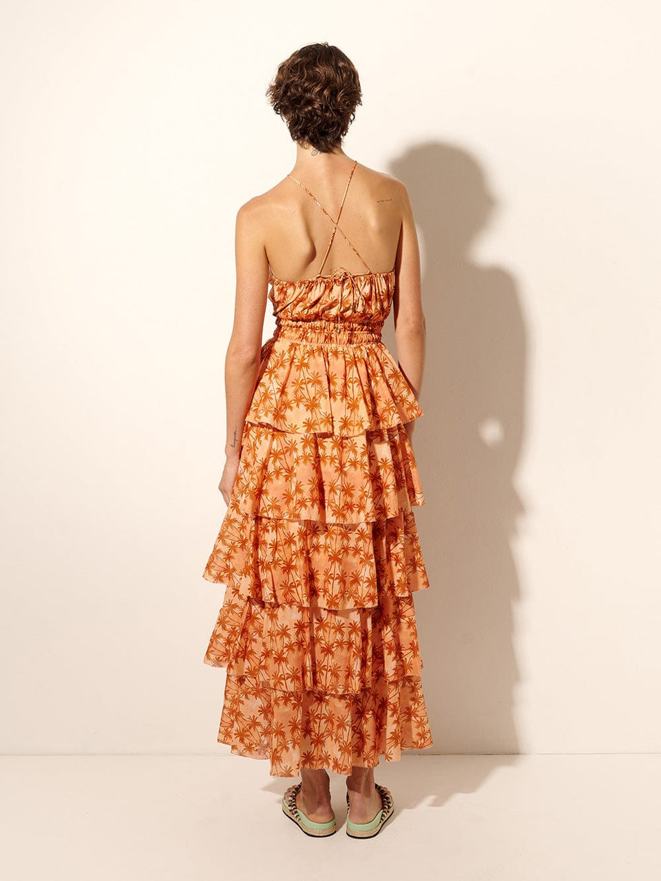 Leilani Maxi Dress KIVARI | Model wears bronze and peach palm printed maxi dress back view