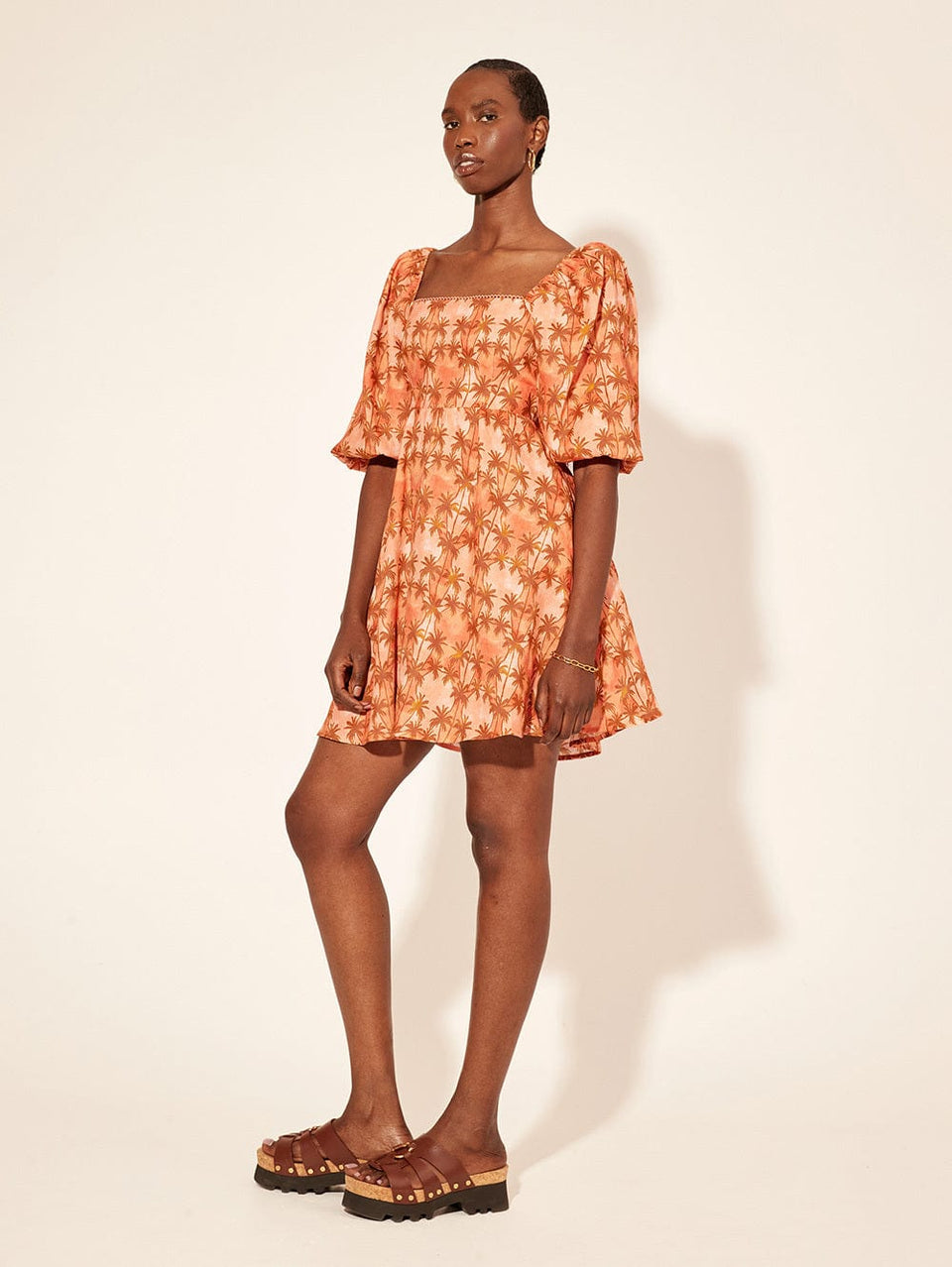 Leilani Mini Dress KIVARI | Model wears bronze and peach palm printed mini dress