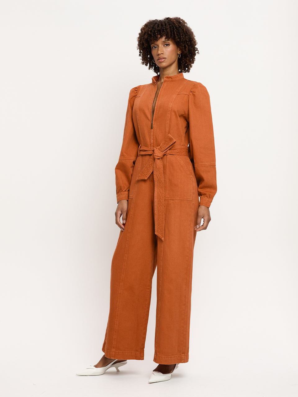 Lourdes Boilersuit Rust KIVARI | Model wears orange denim boilersuit side view