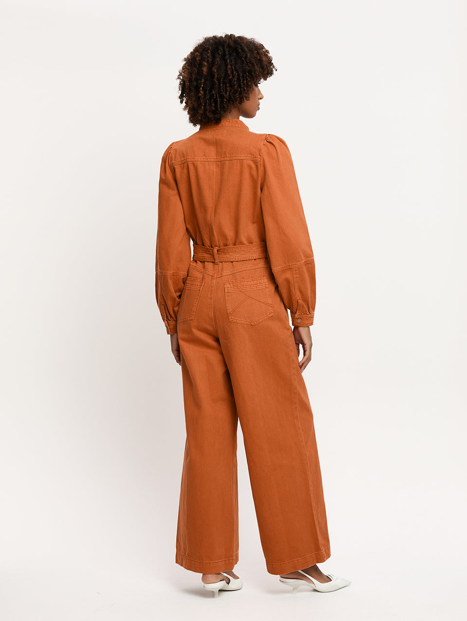 Lourdes Boilersuit Rust KIVARI | Model wears orange denim boilersuit back view