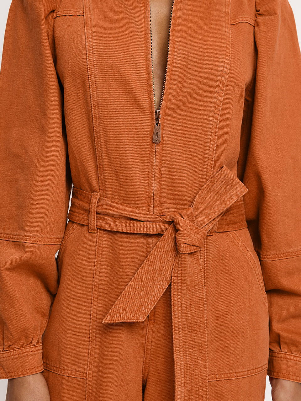 Lourdes Boilersuit Rust KIVARI | Model wears orange denim boilersuit close up