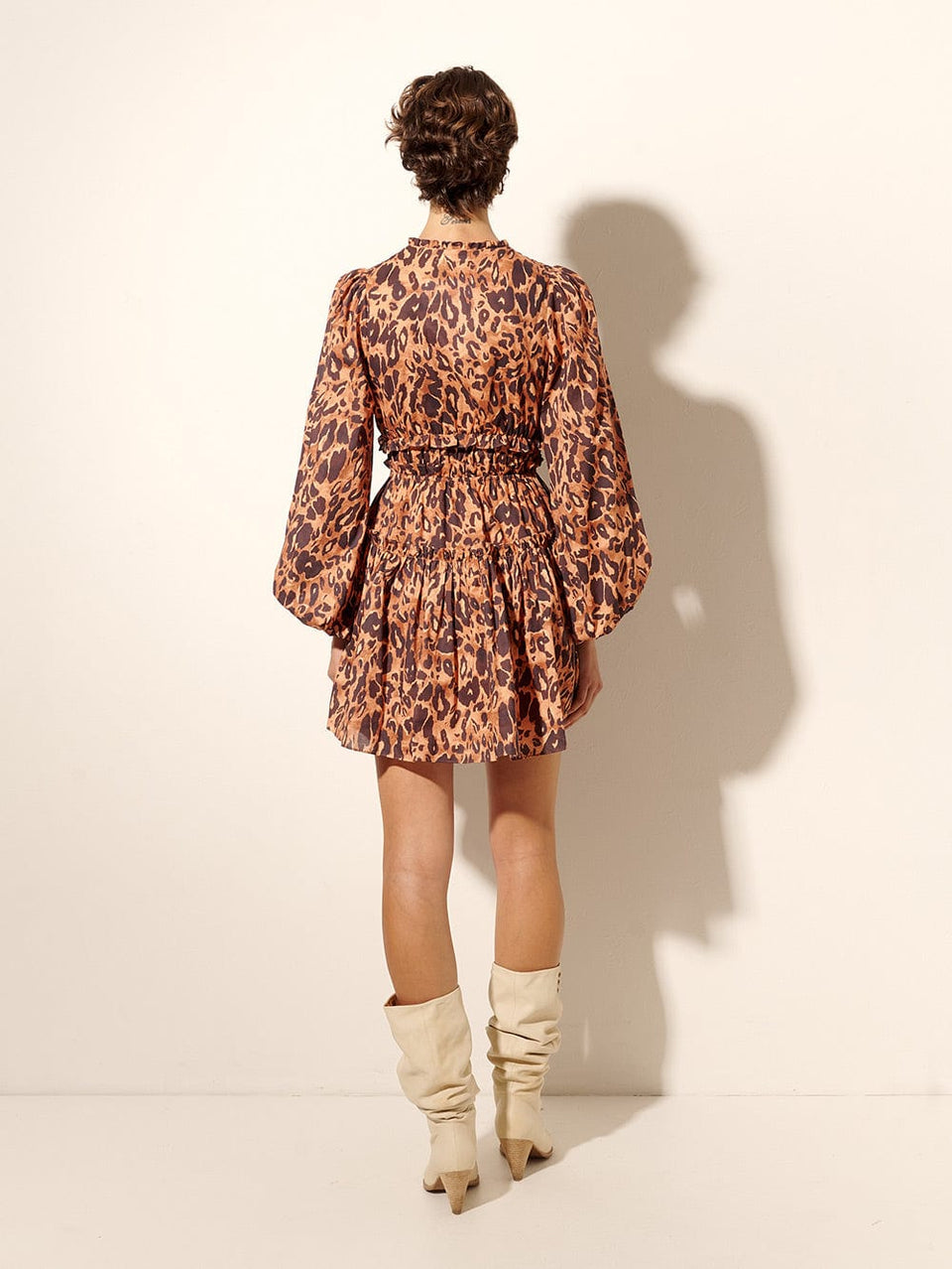 Madison Mini Dress KIVARI | Model wears orange and brown leopard mini dress back view