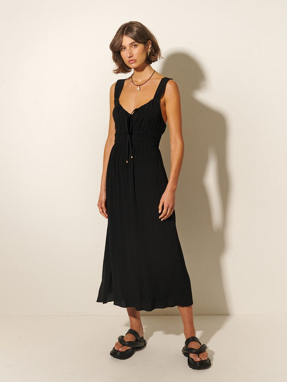 Maria Strappy Midi Dress KIVARI | Model wears black midi dress side view