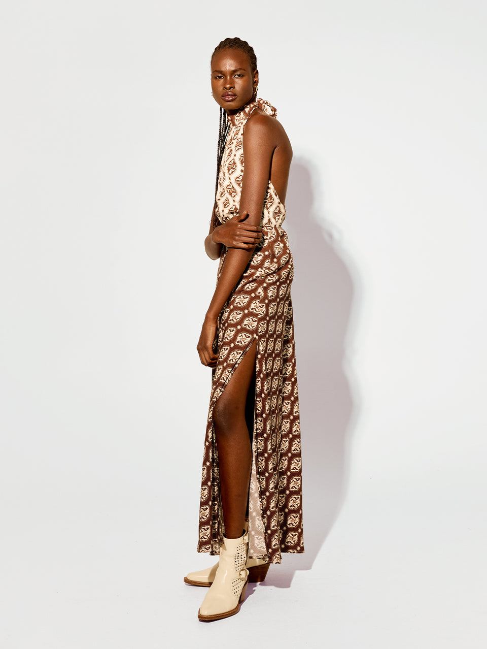 Melody Maxi Dress KIVARI | Model wears brown and cream print halter dress side view