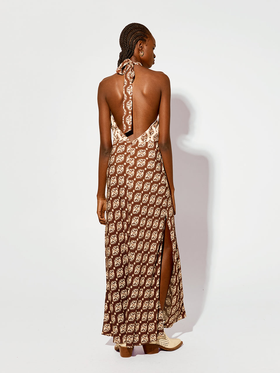 Melody Maxi Dress KIVARI | Model wears brown and cream print halter dress back view