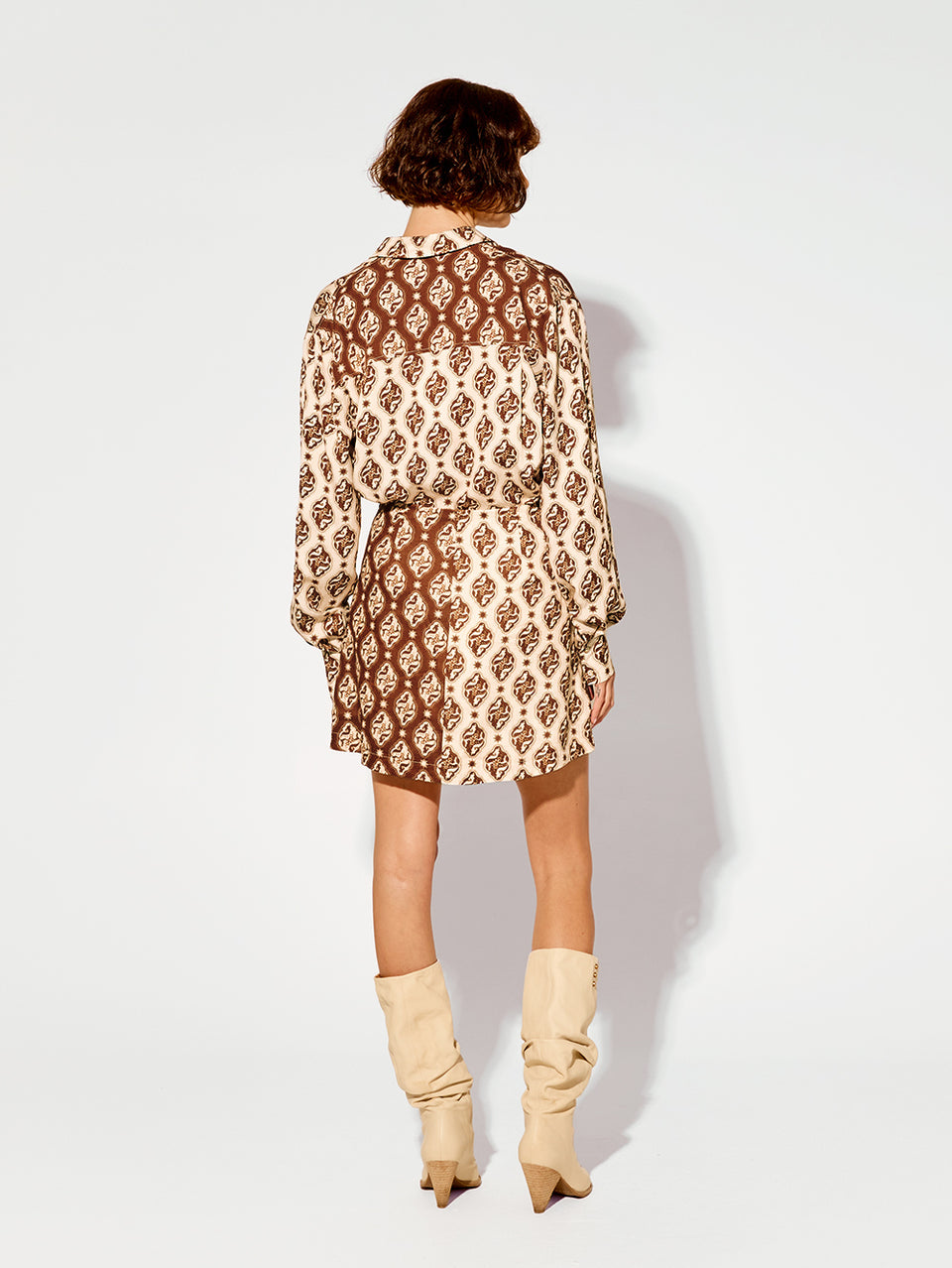 Melody Mini Skirt KIVARI | Model wears brown and cream print mini skirt back view