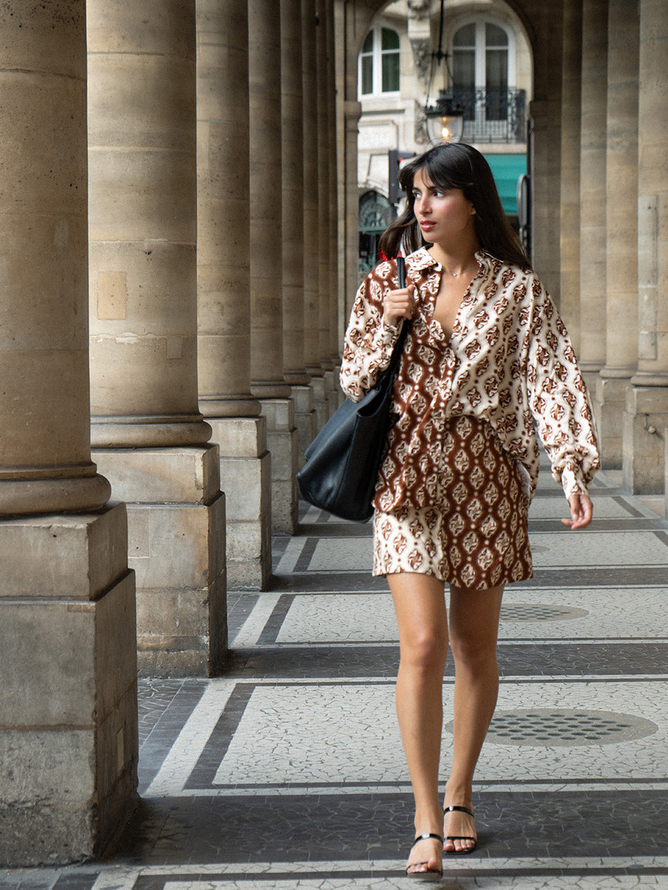 Melody Mini Skirt KIVARI | Model wears brown and cream print mini skirt campaign