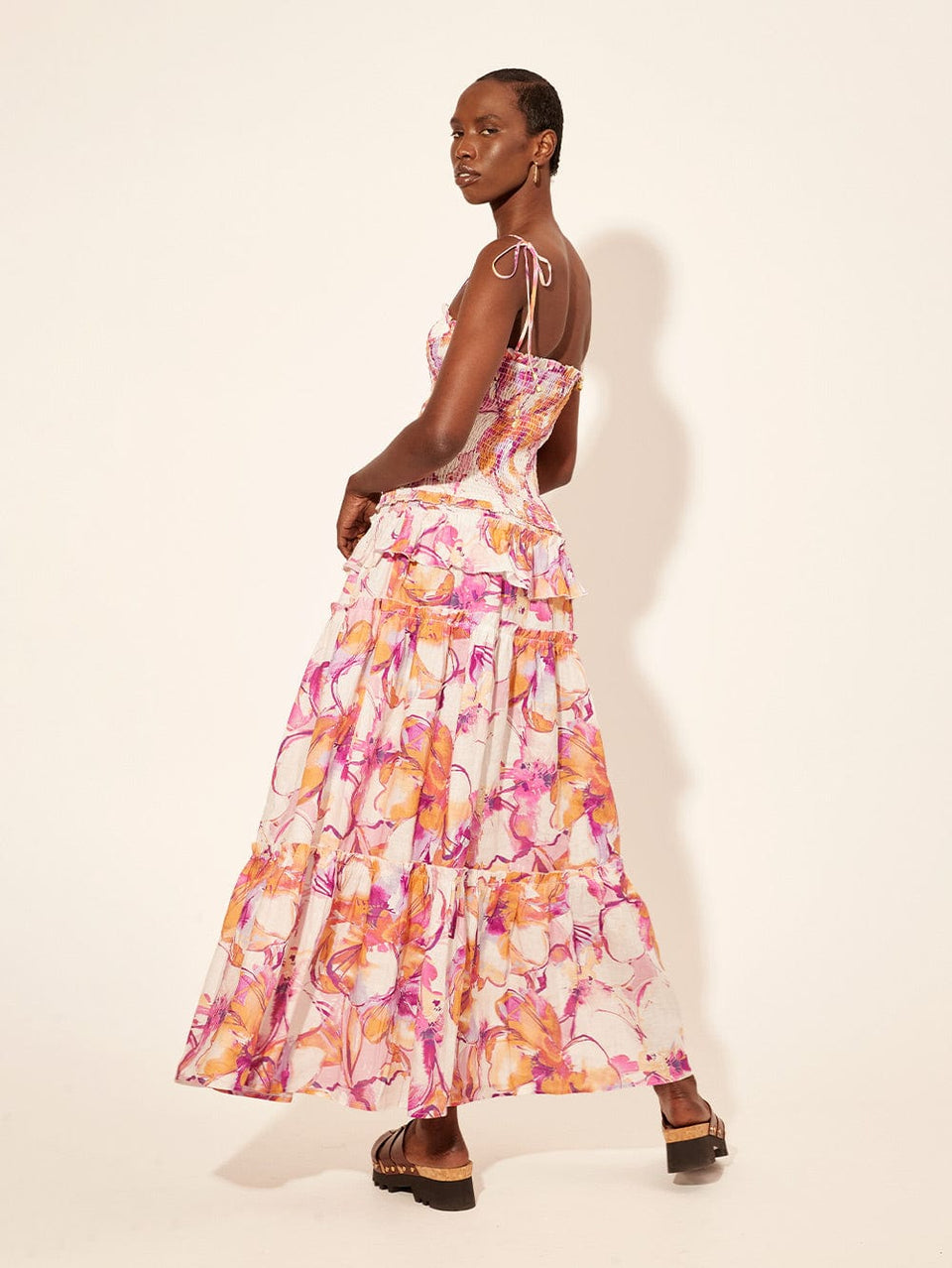 Nadia Strappy Maxi Dress KIVARI | Model wears pink and orange watercolour floral strappy maxi dress back view