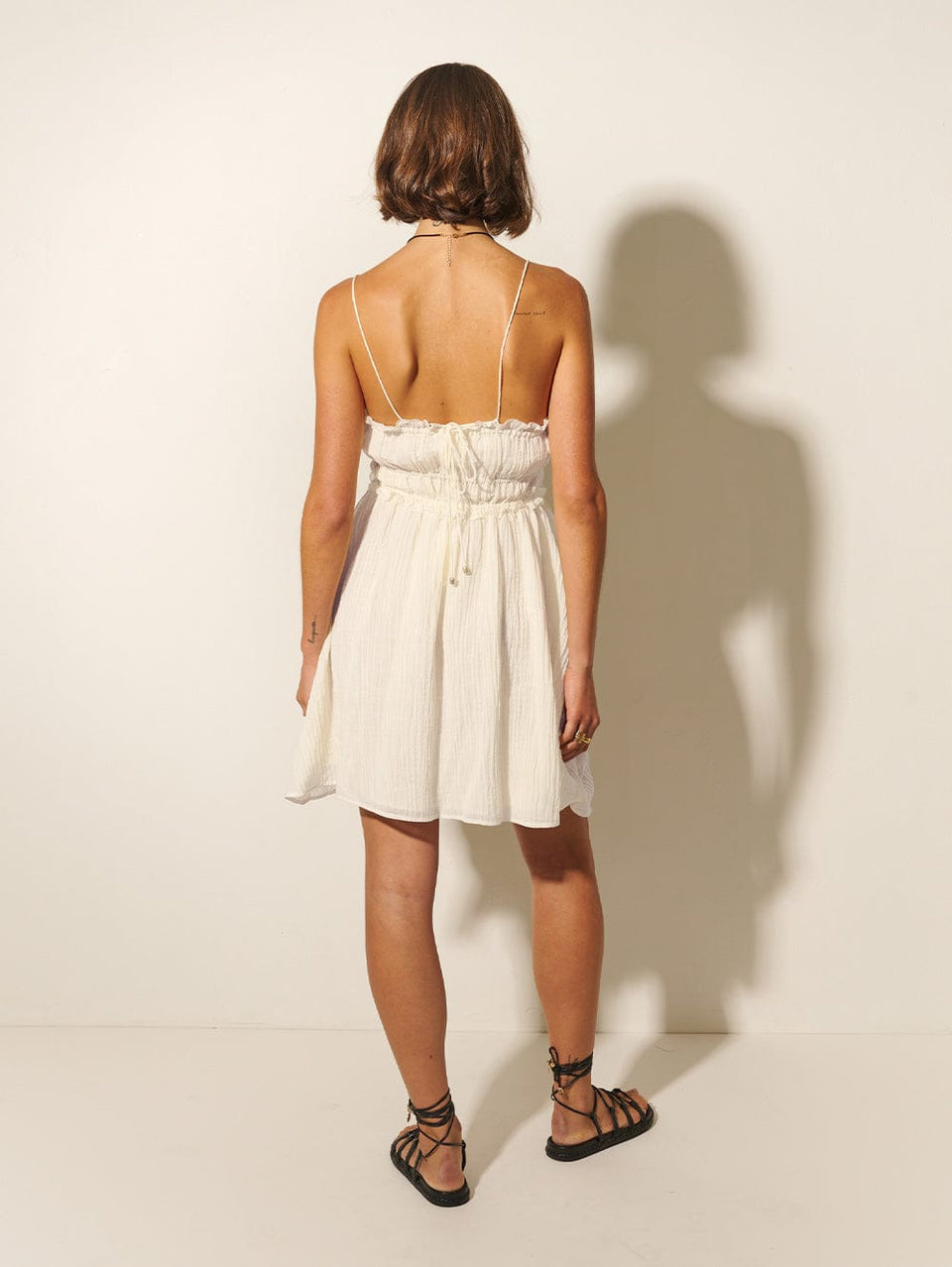 Nora Mini Dress KIVARI | Model wears ivory mini dress back view