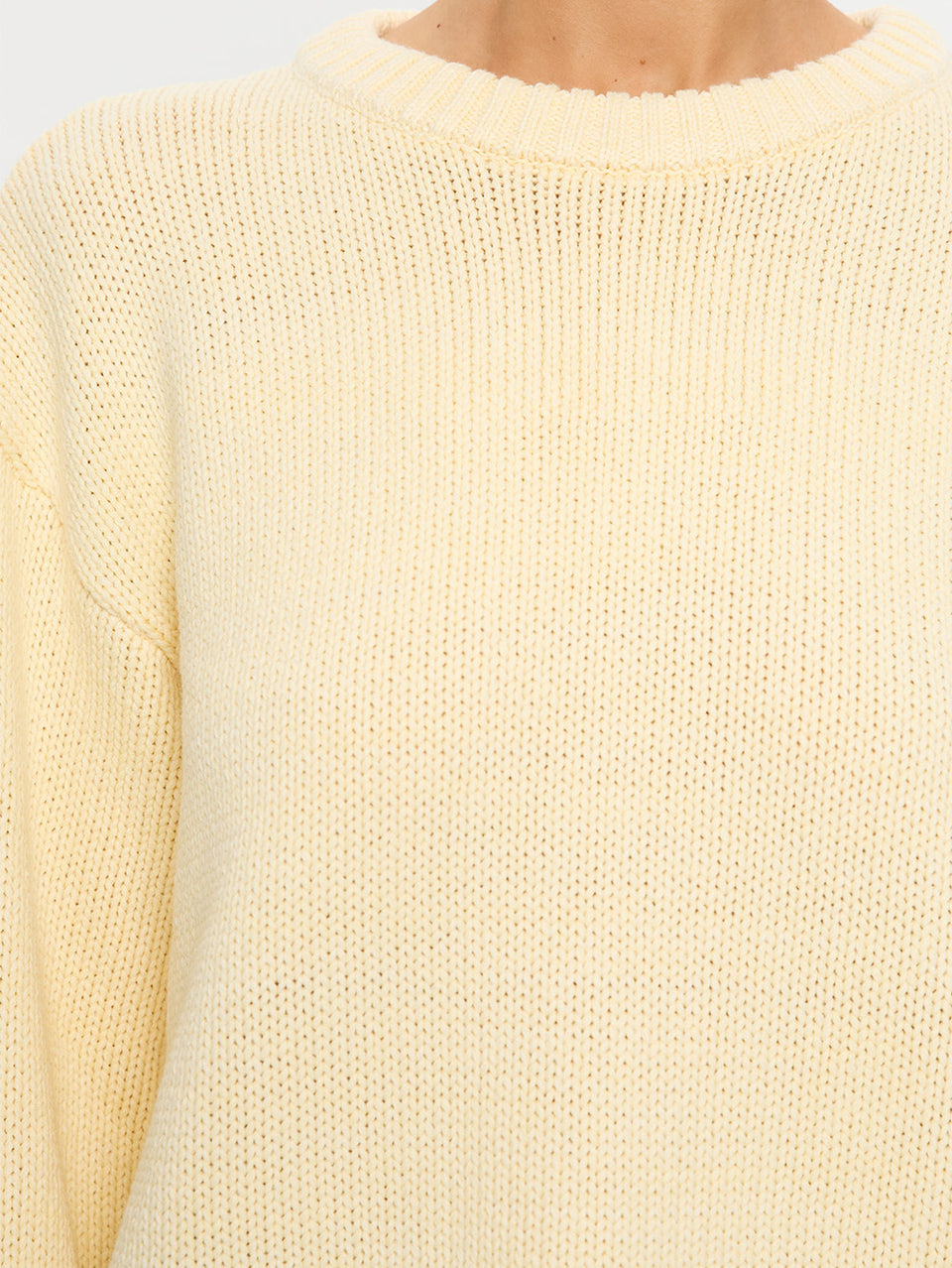 Close-up of a pale yellow sweater with a soft texture
