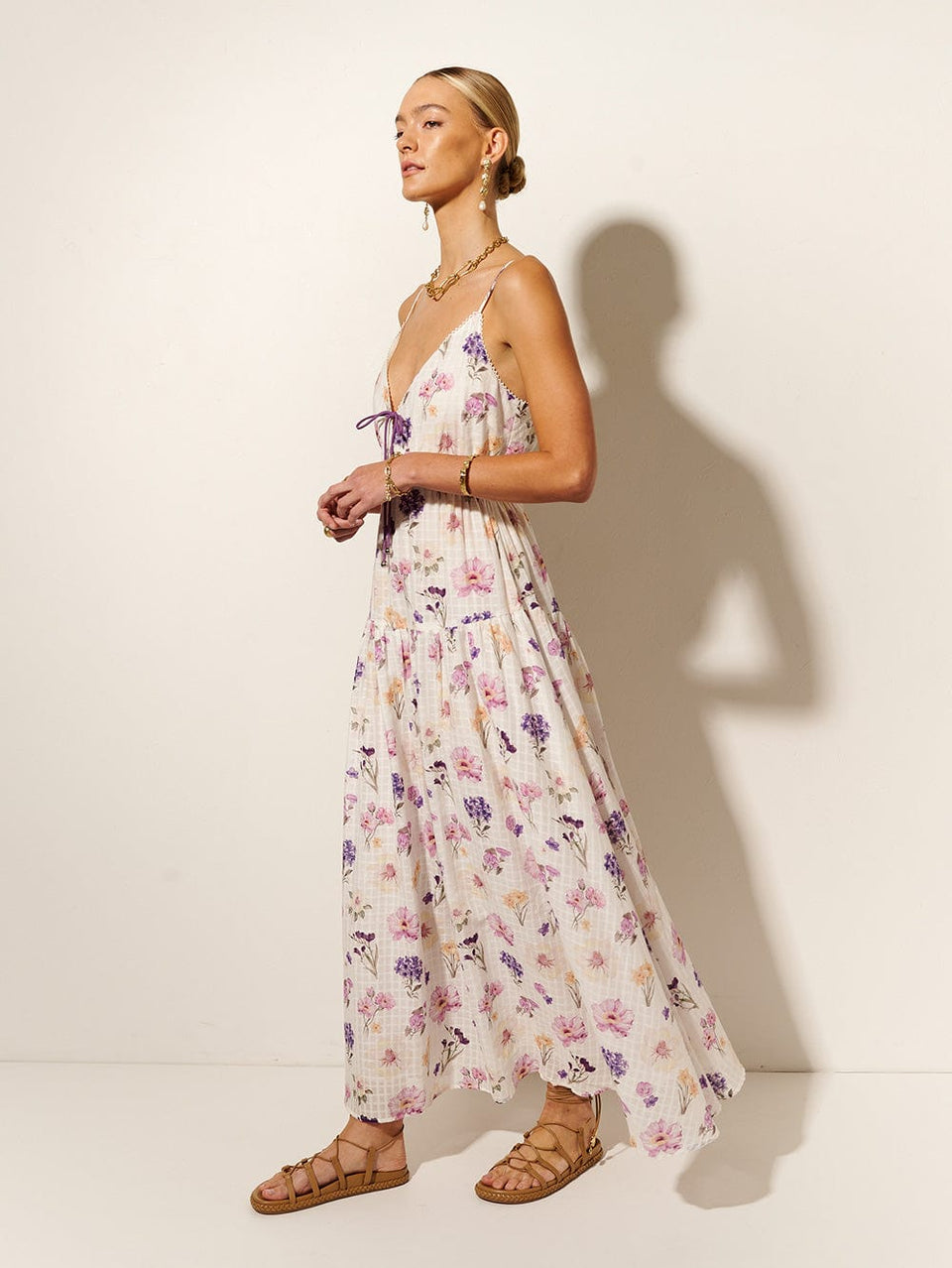 Phoebe Maxi Dress KIVARI | Model wears ivory and purple floral maxi dress side view
