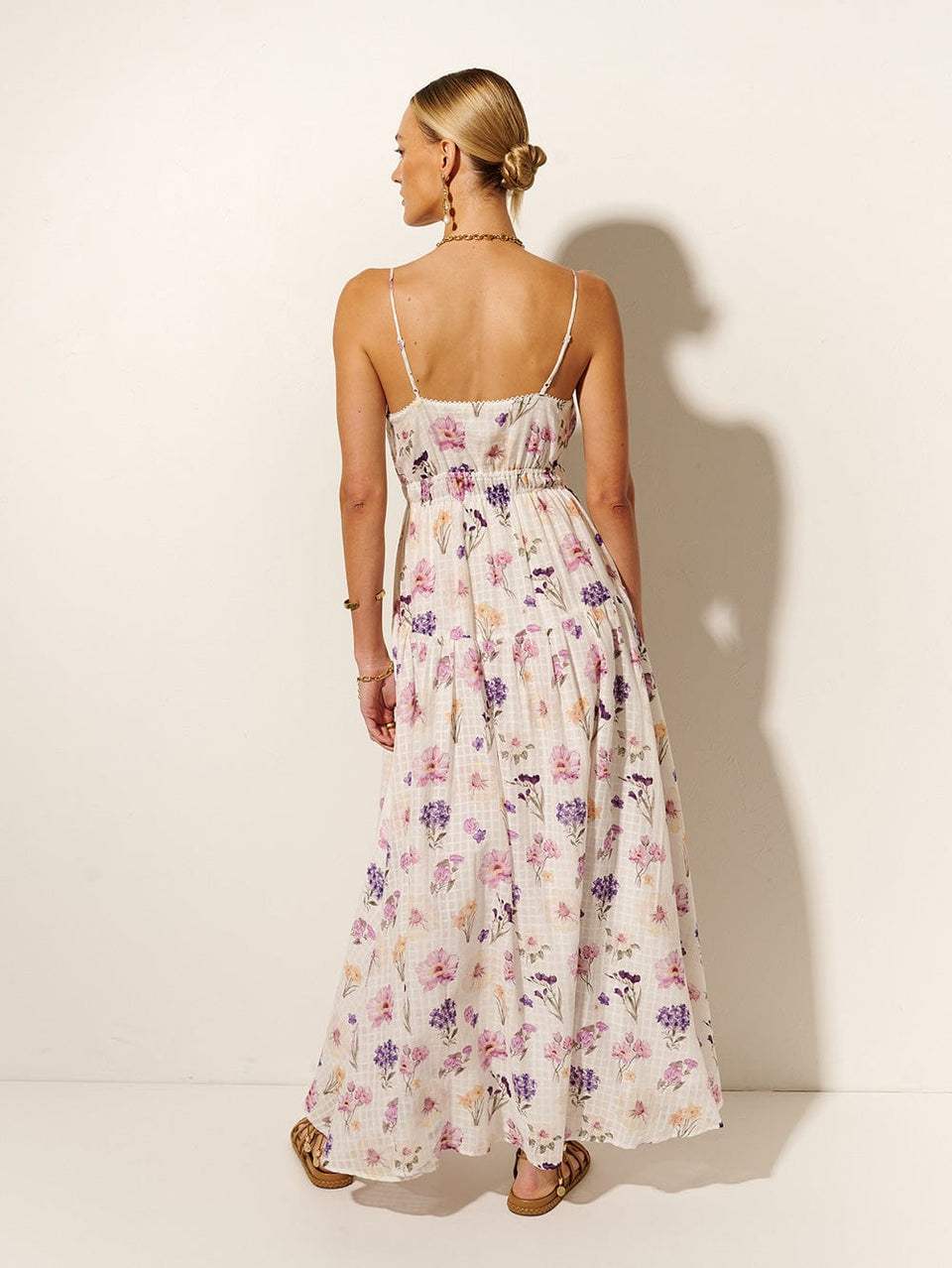 Phoebe Maxi Dress KIVARI | Model wears ivory and purple floral maxi dress back view