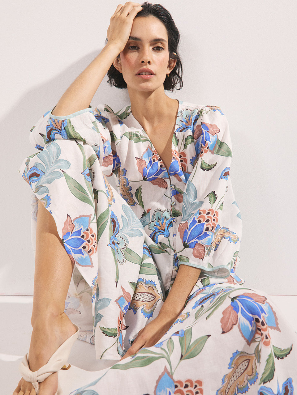 Woman wearing a floral dress with a white background